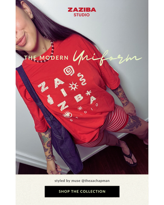 Person wearing a red t-shirt with 'Zaziba' branding and striped pants, styled by Zaziba Studio.