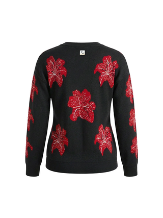 Black sweater with red floral patterns on a white background