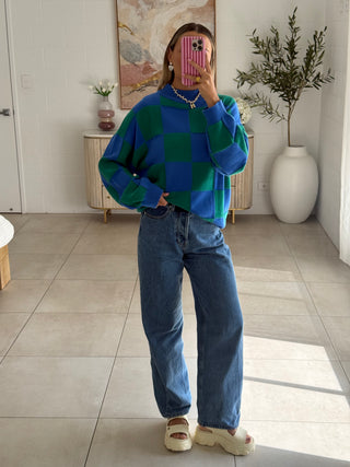 Model wearing Blue and Green checked knitted jumper