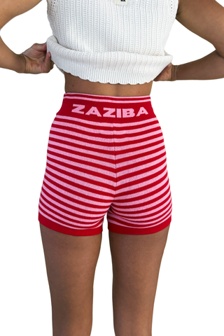 Red and white striped shorts with 'Zaziba' branding worn by a person on a white background