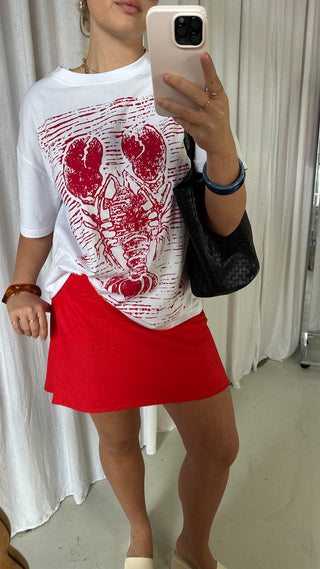Girl wearing red mini skirt and lobster print tshirt