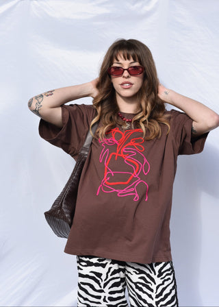 Poppy art tee in brown with pink and red embroidery design worn with zebra print pants