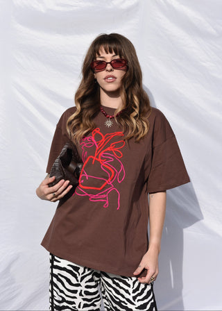 Poppy art tee in brown with pink and red embroidery design worn with zebra print pants