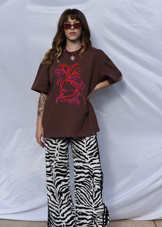 Poppy art tee in brown with pink and red embroidery design worn with zebra print pants