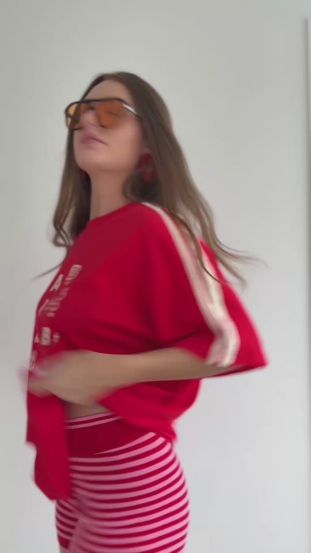 Girl trying on a red tshirt