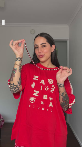 Girl trying on a red tshirt